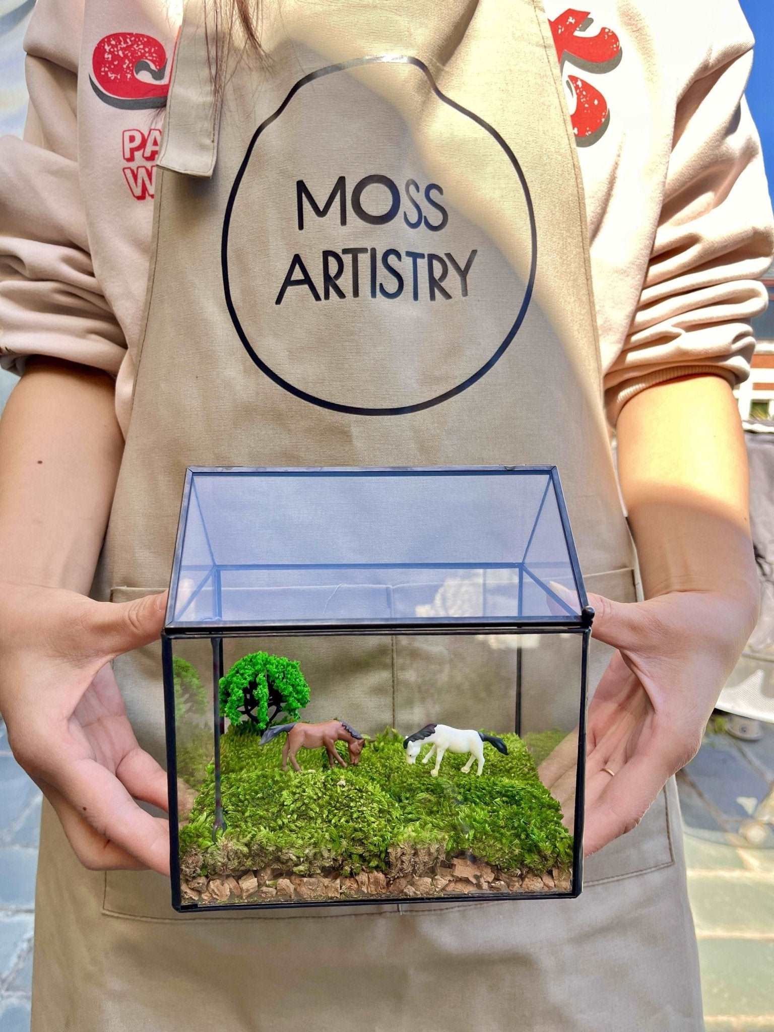 Tranquil Pasture Handmade Glass Terrarium - Miniature Equestrian LandsIntroduce a serene and picturesque scene to your workspace with our "Tranquil Pasture" Handmade Glass Terrarium - a Miniature Equestrian Landscape. This enchanting w